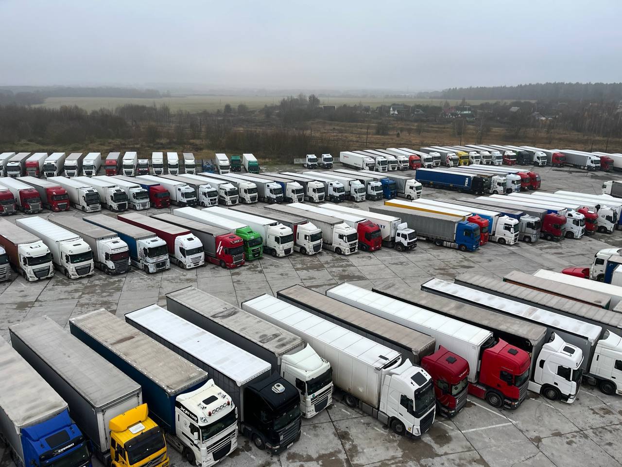 Rows of semi-trucks parked at a logistics yard