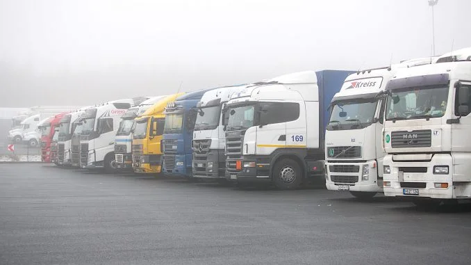 Semi-trucks lined up at a logistics base